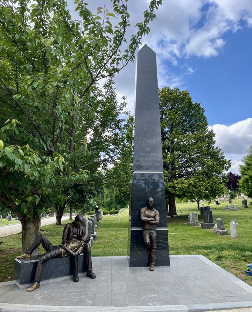 Black granite obelisk with two bronze figures, at Congressional Cemetery, Washington DC