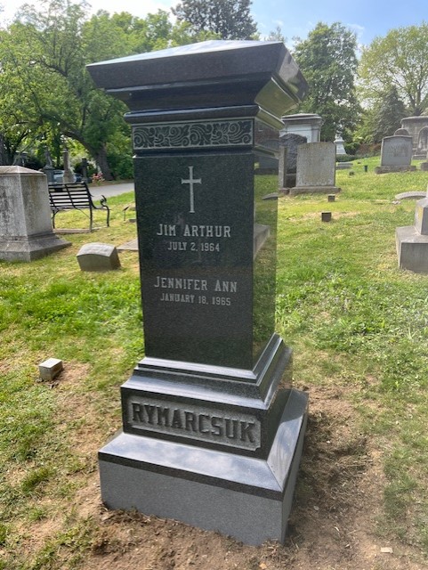 Granite obelisk memorial standing in a cemetery