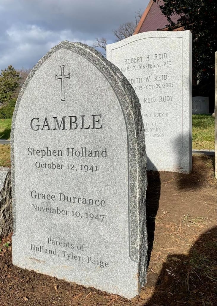 Pale granite monolith memorial standing in a cemetery